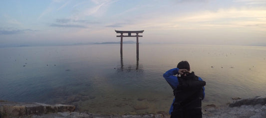 A female cyclist enjoying the amazing Shirahige shrine at Lake Biwa, Japan.